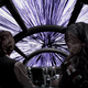 Han Solo and Chewbacca look out of the cockpit of the Millennium Falcon, as it accelerates to Lightspeed in preparation to jump into Hyperspace.